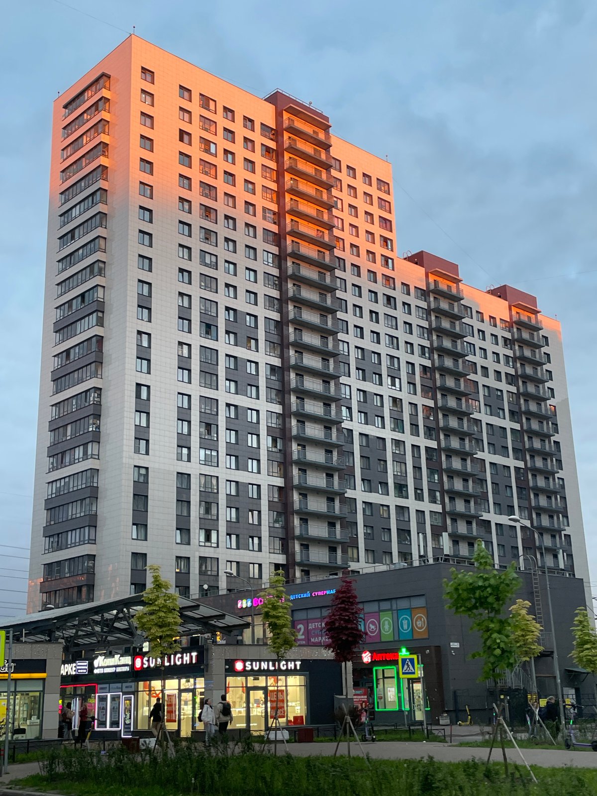 Evening cityscape captured showing modern residential buildings at sunset