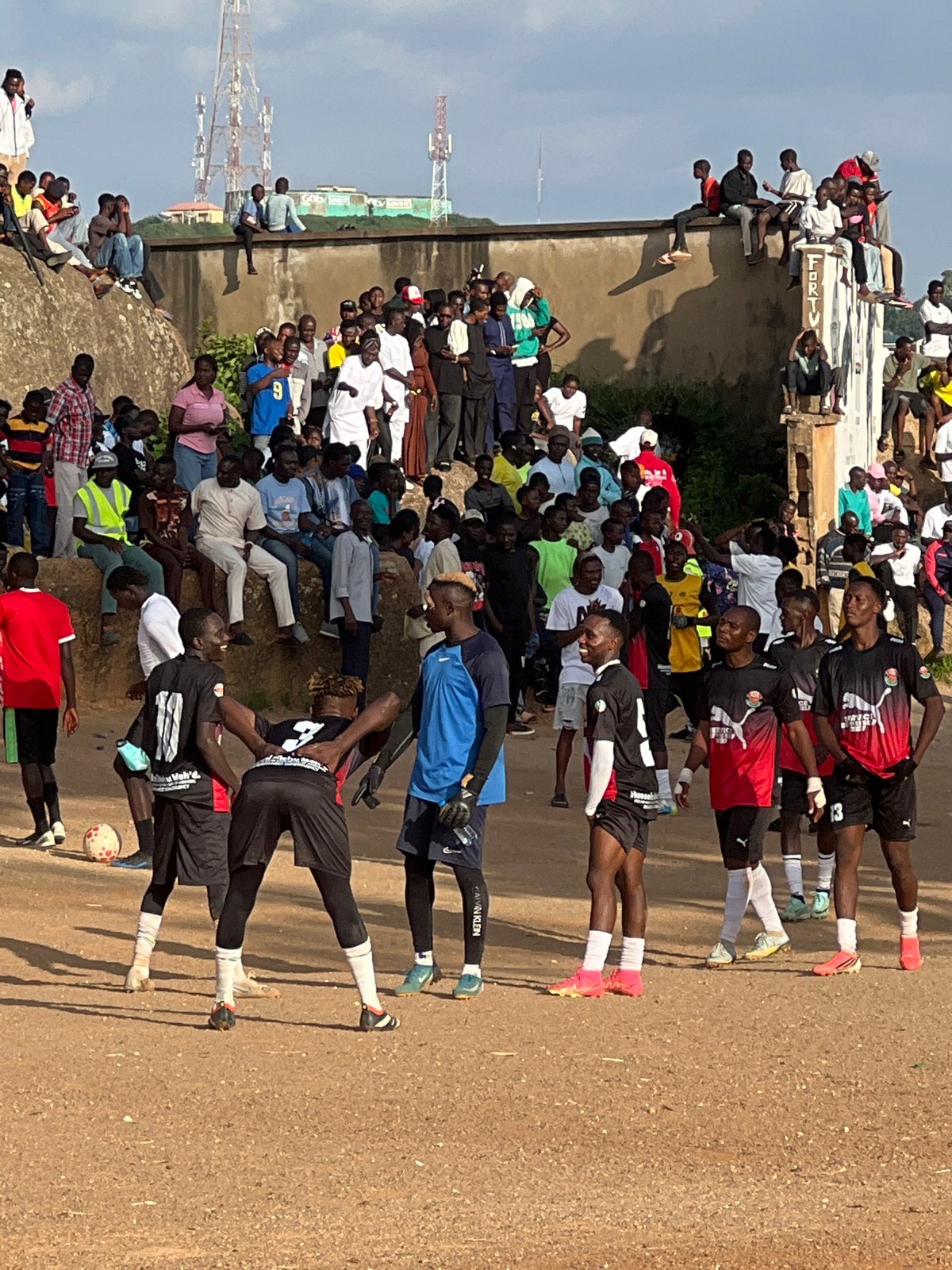 Grassroots football match and trophy moment in Jos, Nigeria
