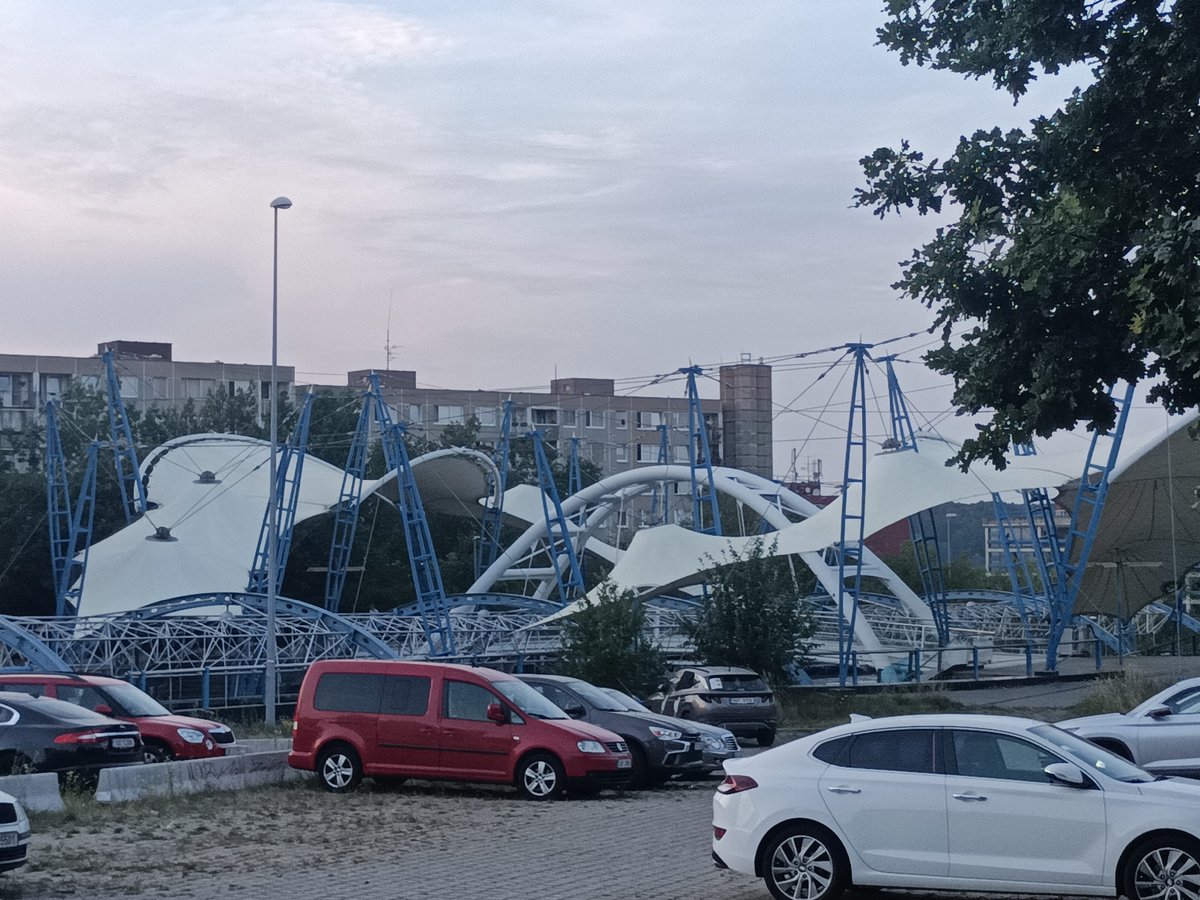 Evening transit loop through Prague, ending at a tent-roof venue