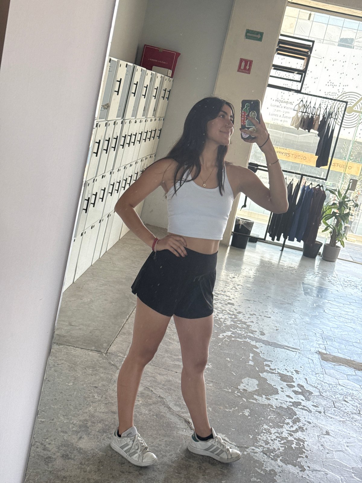 Woman takes mirror selfies, uses Apple devices in Puebla studio