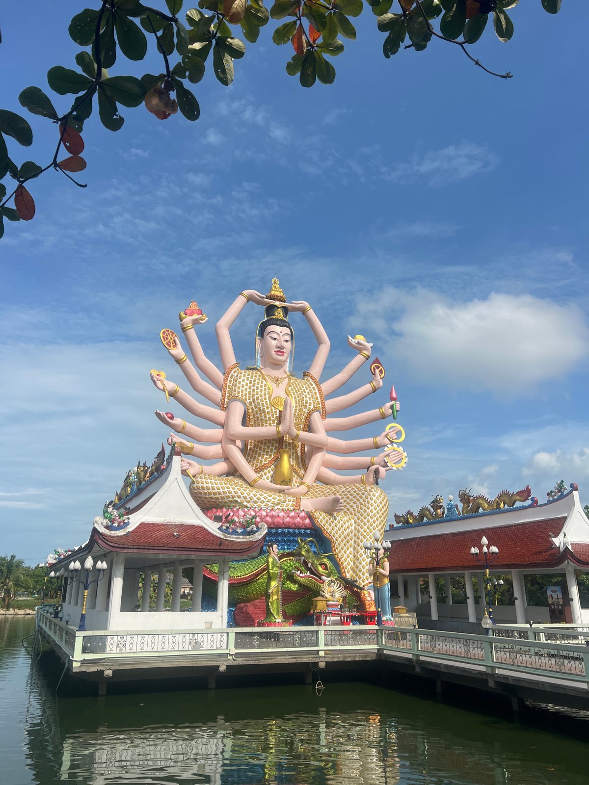 Tourist visits Wat Plai Laem temple, documents statues and wildlife