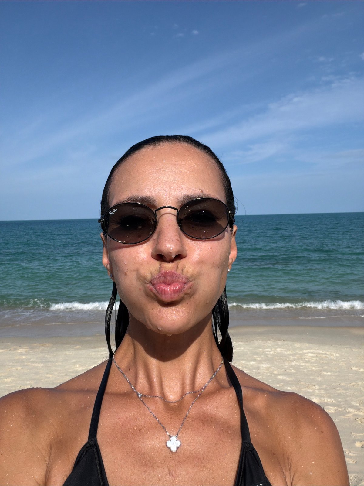 Beachside selfie with ocean backdrop on a sunny day