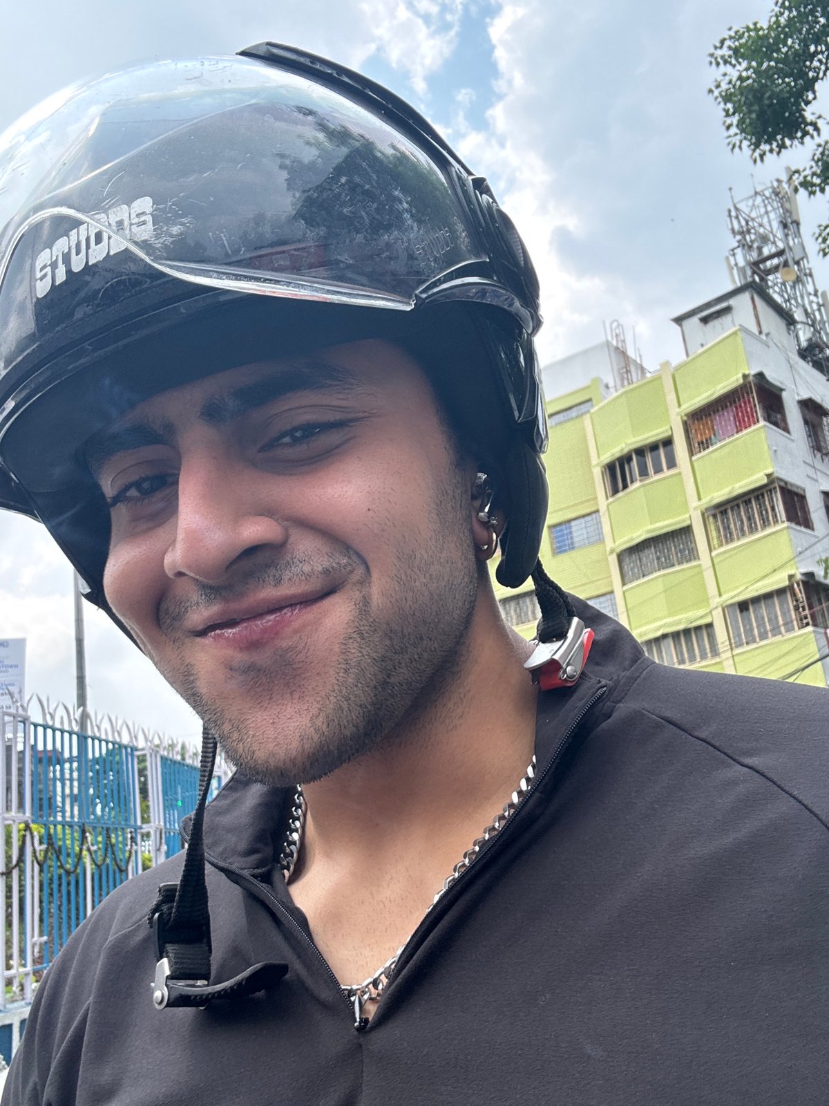 Motorcyclist waits at red light in early morning Kolkata traffic