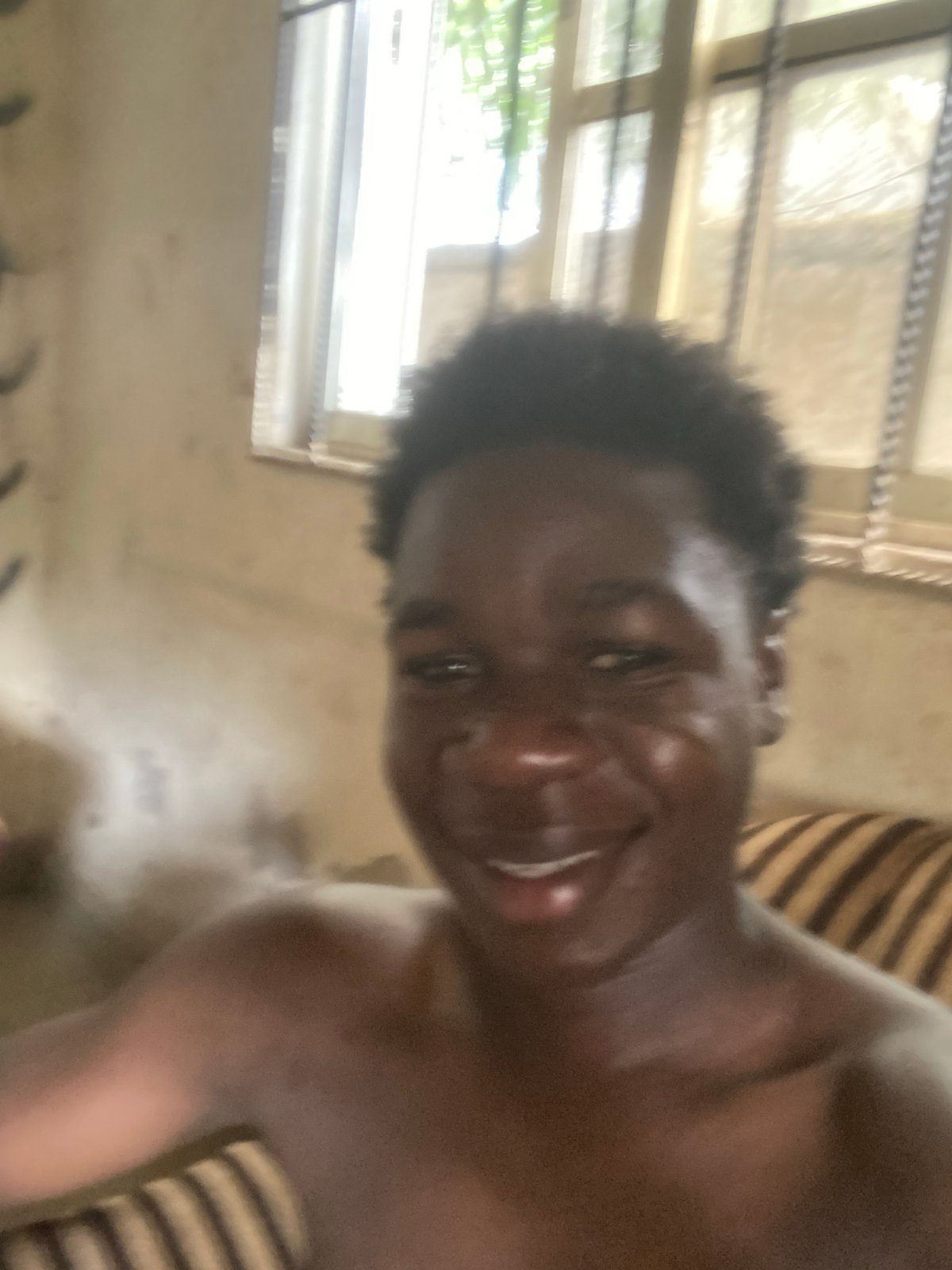 Person photographed smiling indoors in Mararaba, Nigeria residence
