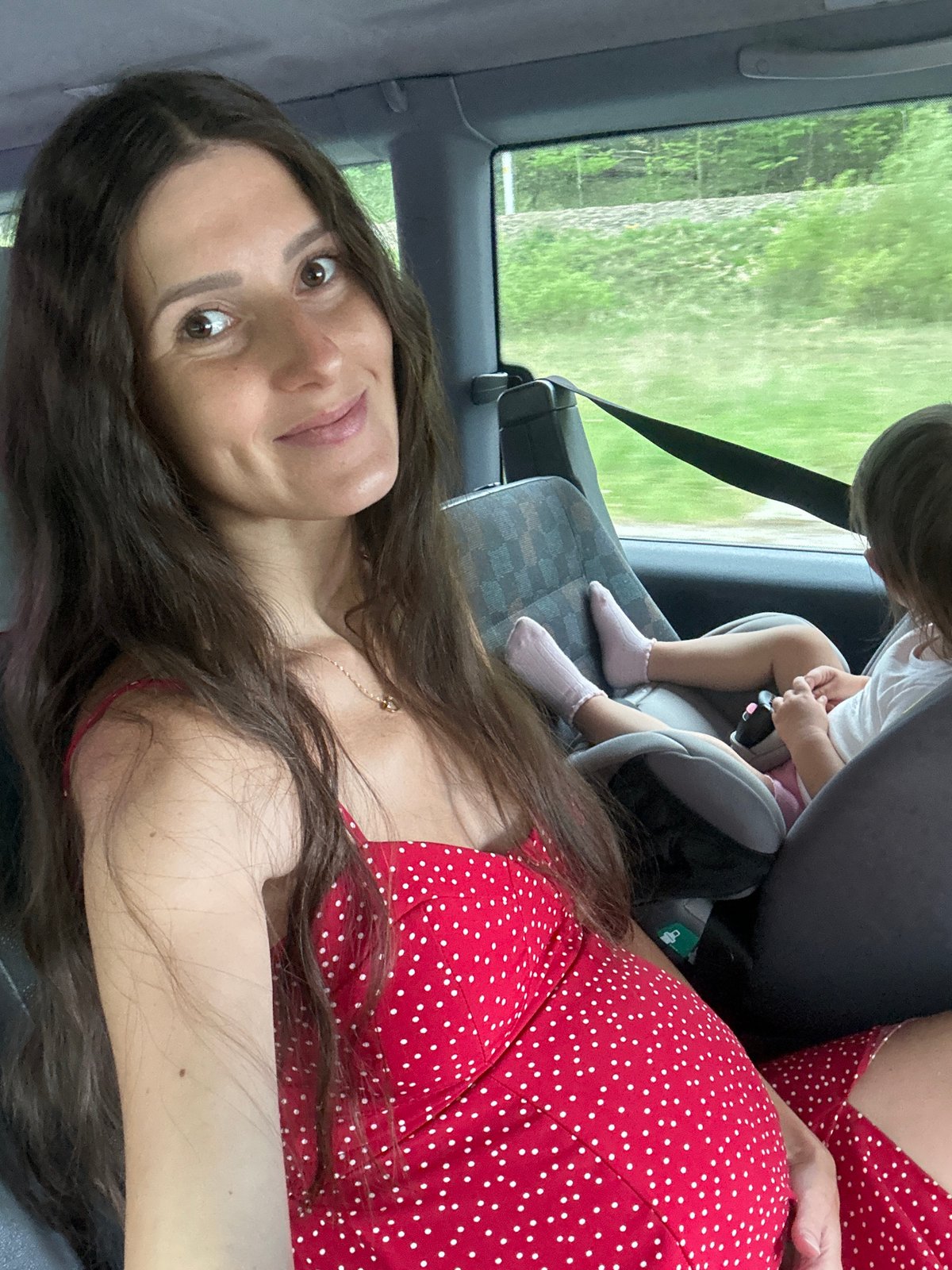 Woman in polka-dot dress photographed inside vehicle in Poland