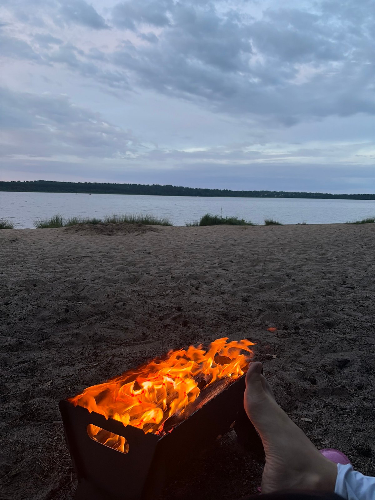 Beach fire at dusk on a Russian lakeshore