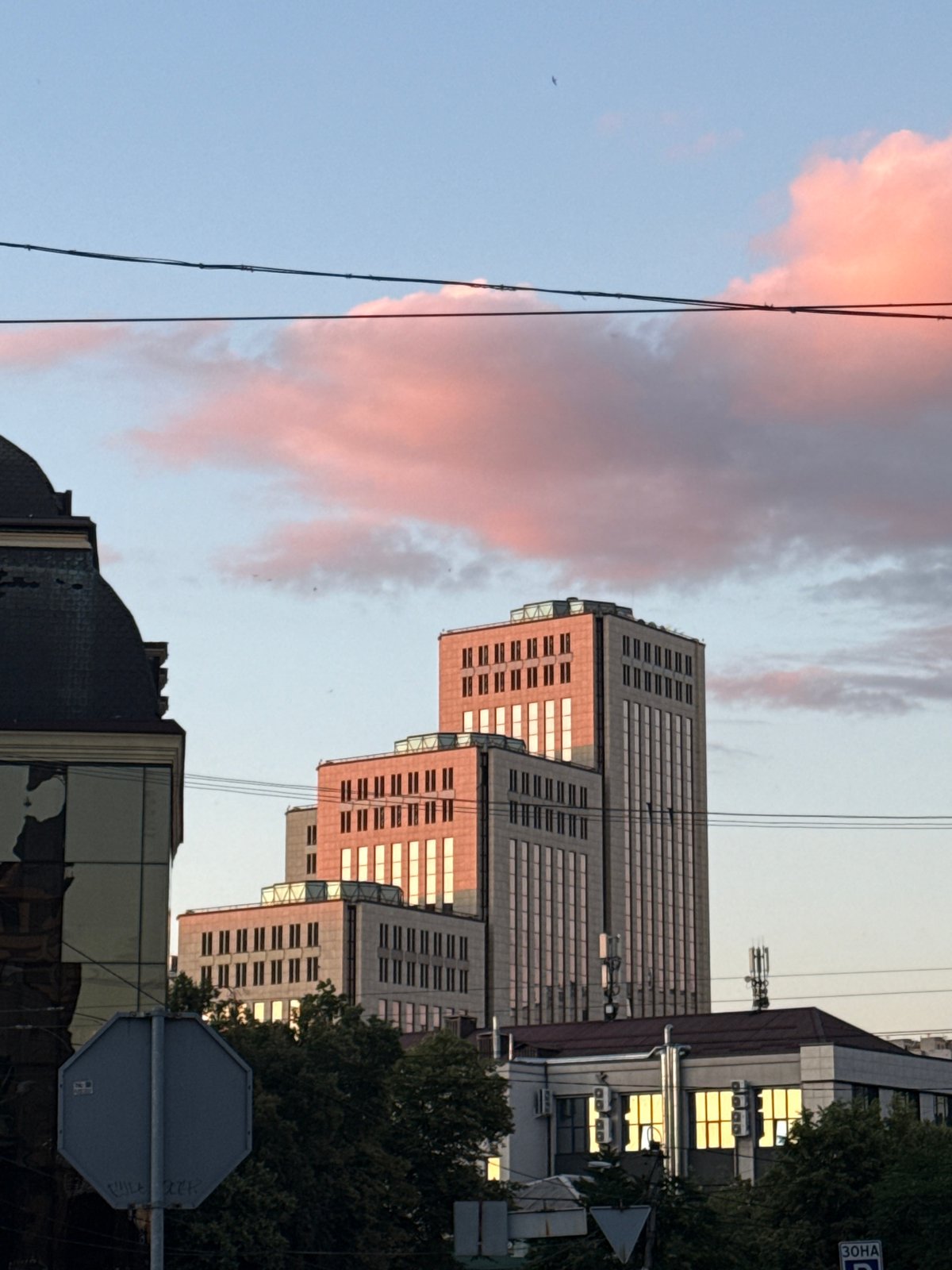 Glass towers rise against a pink dusk sky