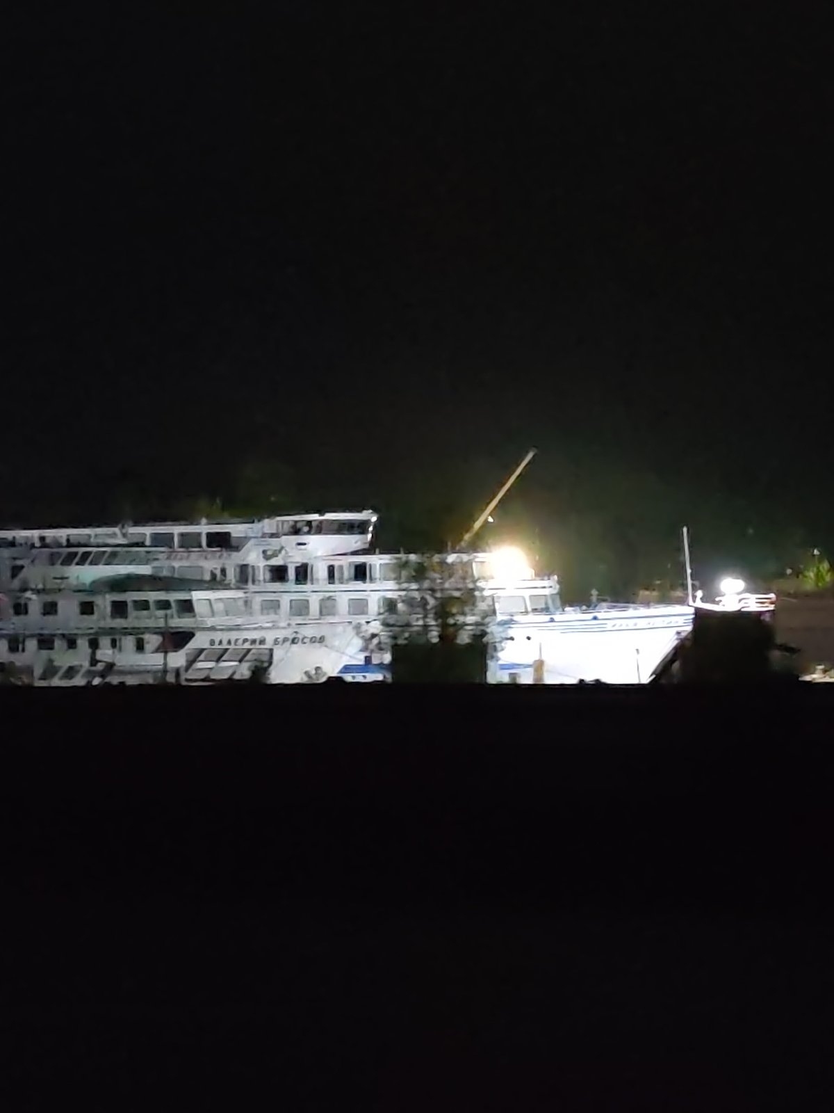 Two vessels docked at night in Kimry, Russia