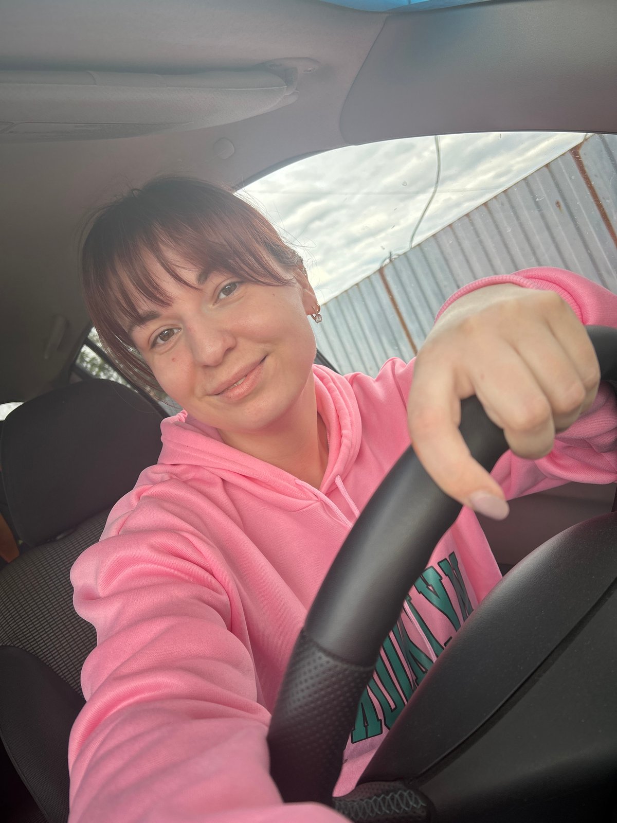 Woman in pink hoodie takes selfies with child in Russia
