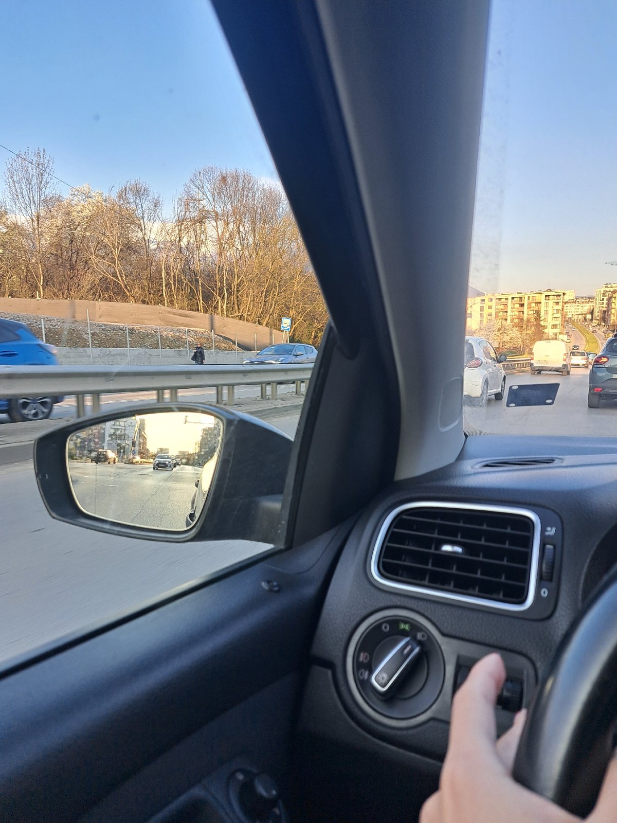 Driver operates dashboard controls in Sofia early morning