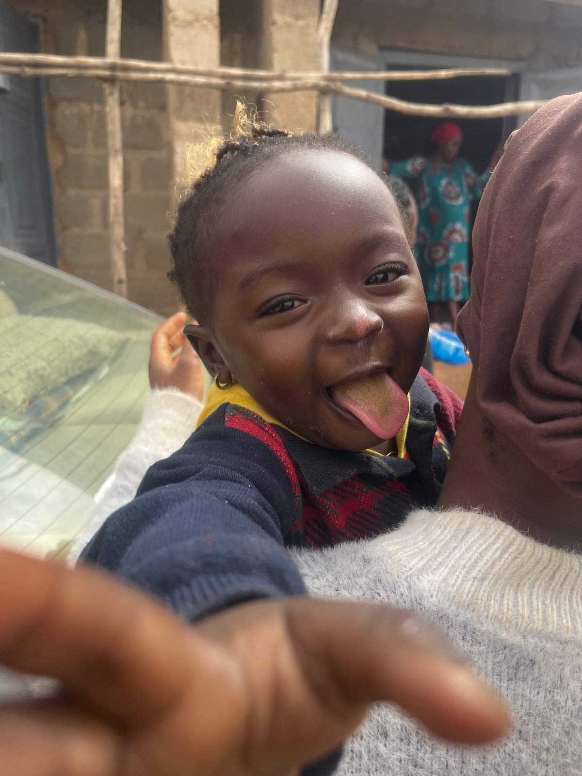 Child plays for camera near construction site in Jos