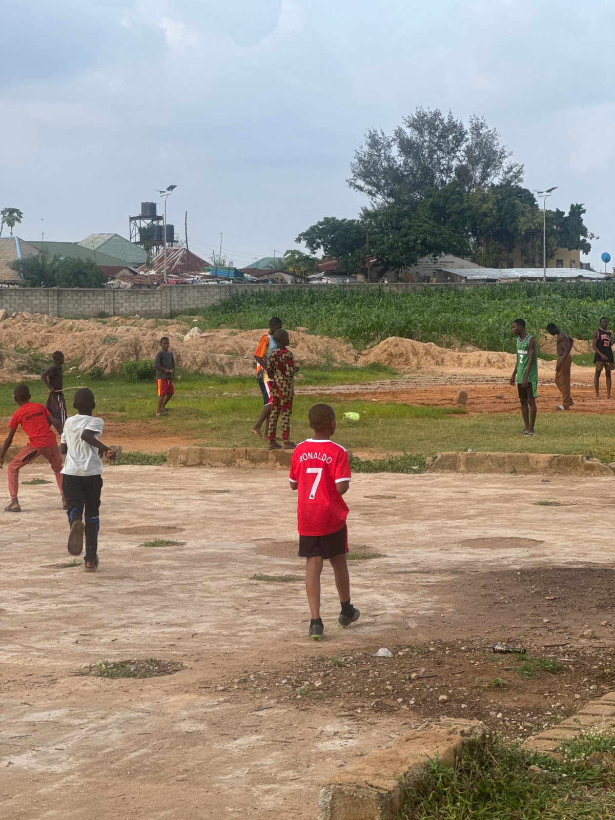 Pickup soccer game on a dirt field in Karum, Nigeria