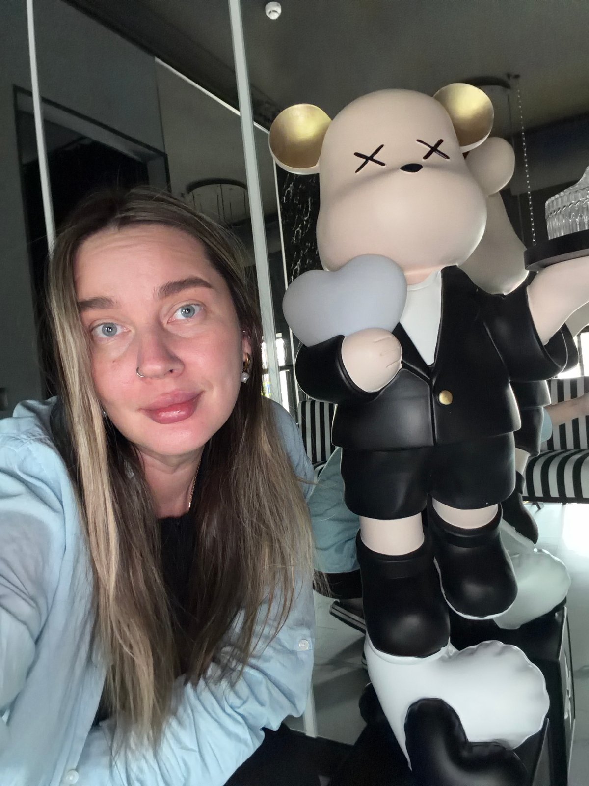 Woman takes selfie with bear figure in Moscow