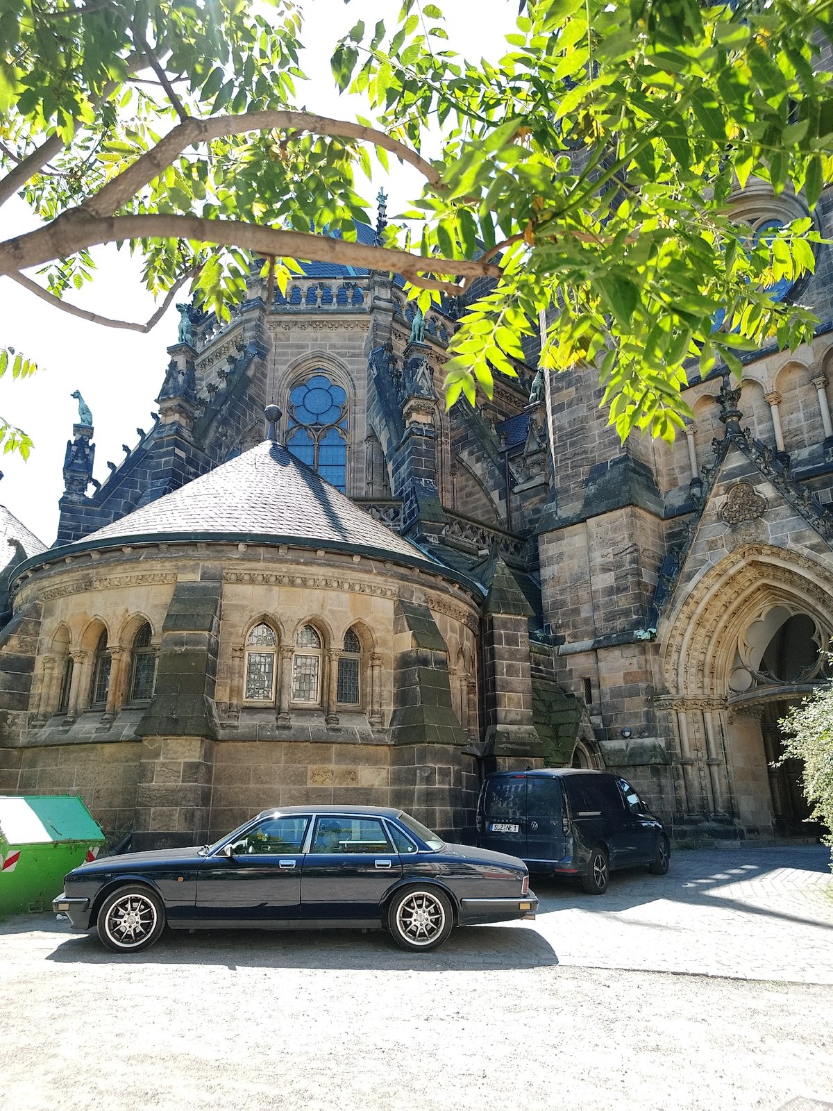 Gothic cathedral, parked Jaguar, street murals, passing tram documented