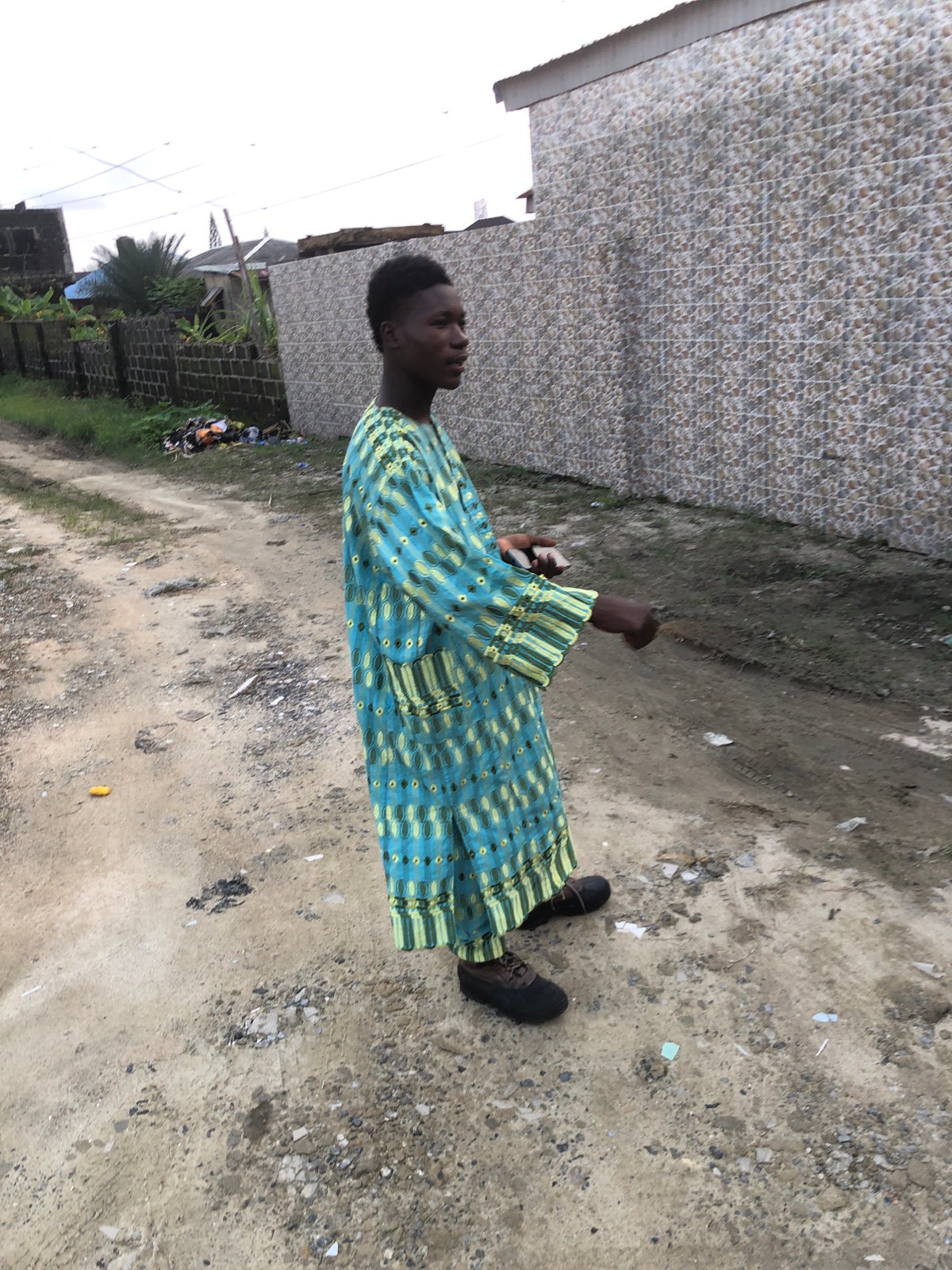 Street scenes in Ado, Nigeria, at sunset along a dusty road