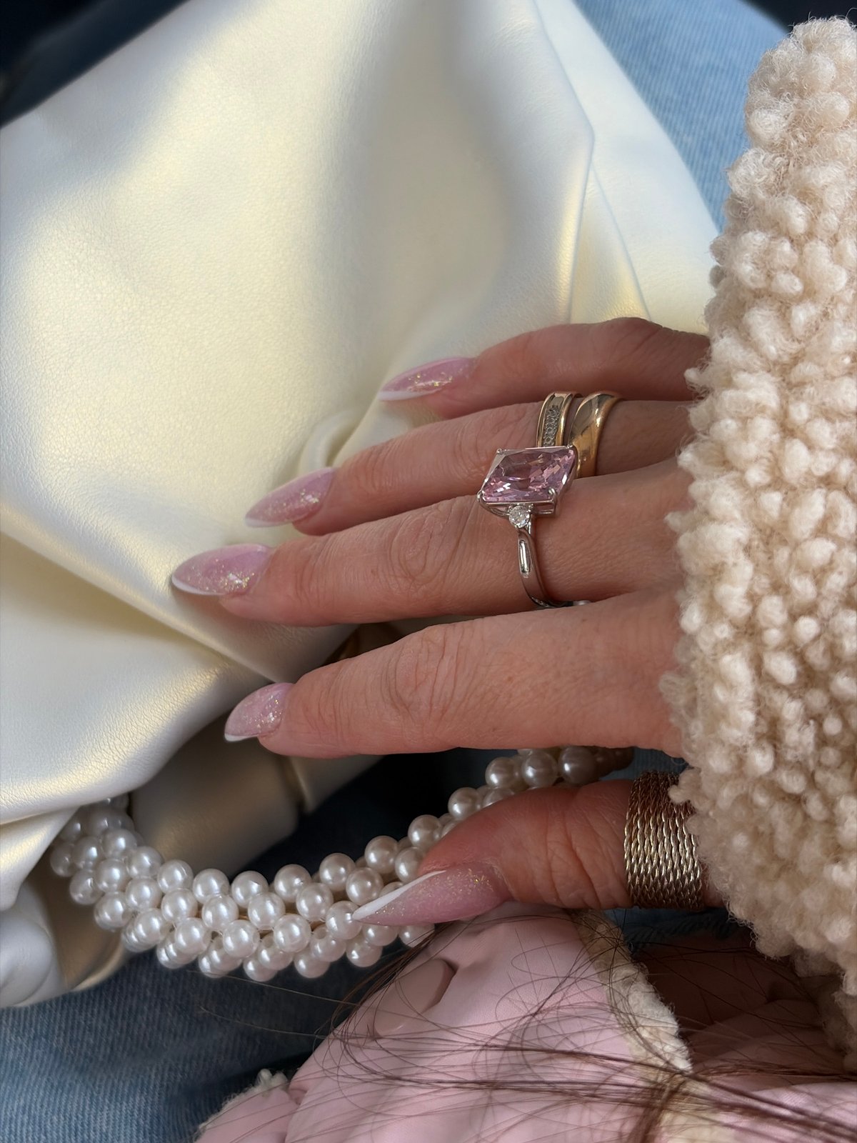 Hand displays ornate rings and pearls in Saint Petersburg