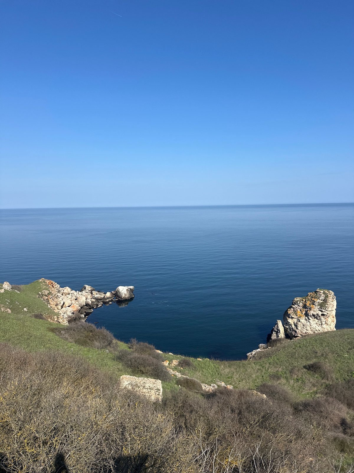 Visitor documents scenic Black Sea cliffs at Kamen Bryag