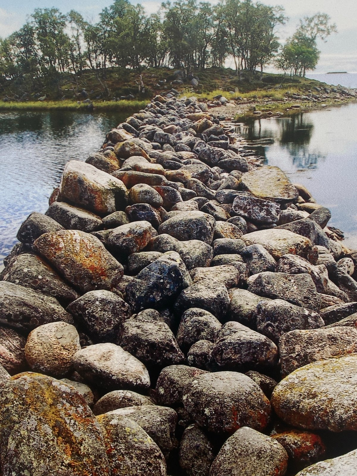 Adult and child rest by stone waterway embankment in Шебунино