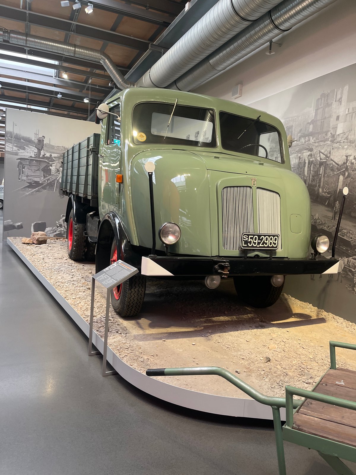 Vintage vehicles and automotive artifacts on display at a museum