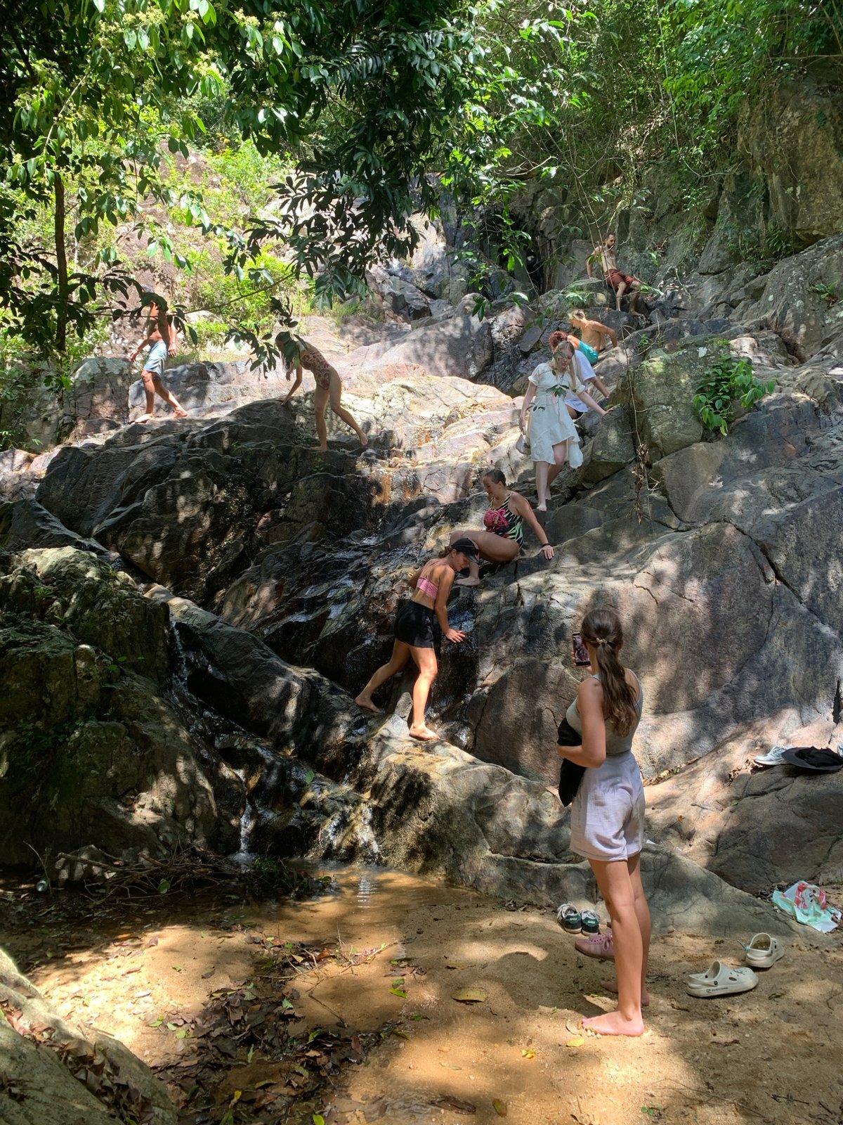 Groups exploring a jungle waterfall on Ko Samui