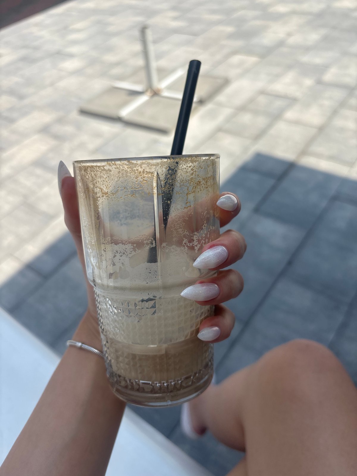 Morning at a Pleven kids' play area with iced coffee in hand
