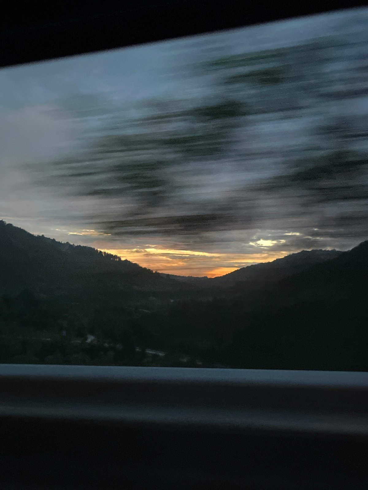 Dramatic sunset captured over Bulgarian mountains from moving vehicle