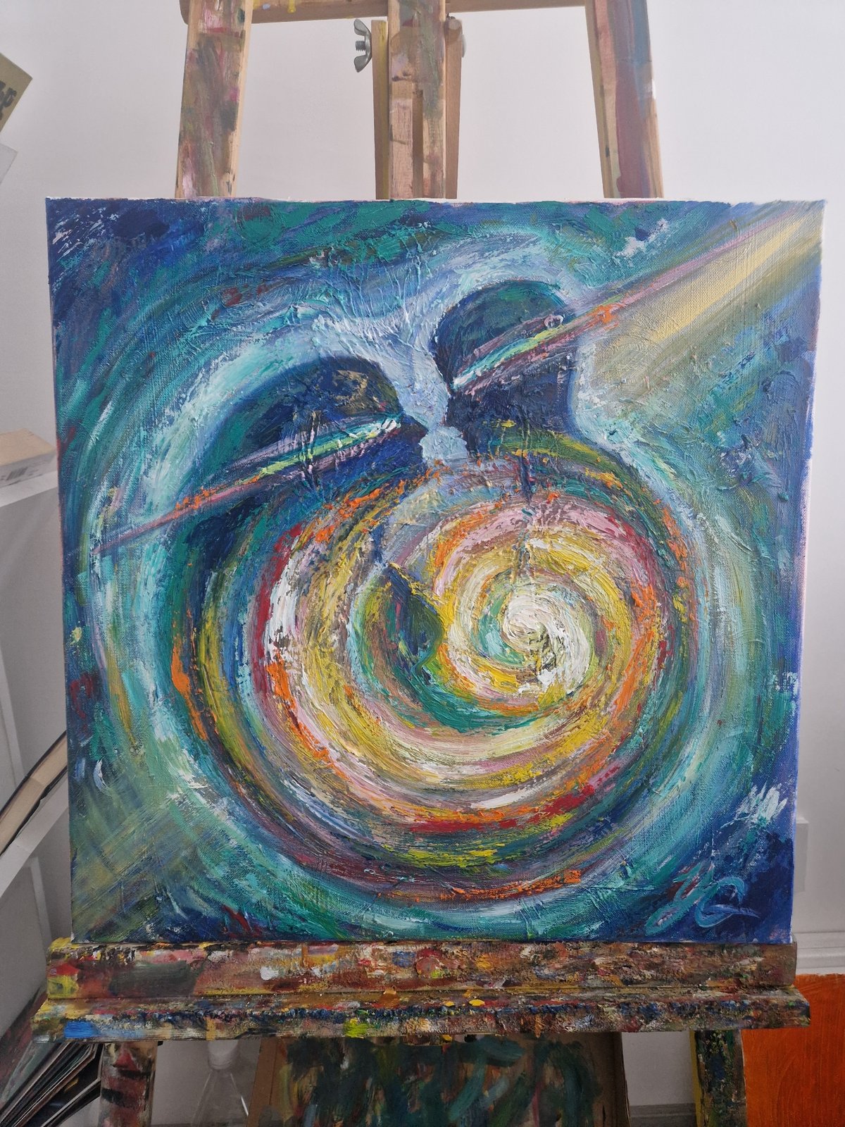 Abstract painting with colorful swirling patterns spotted on easel