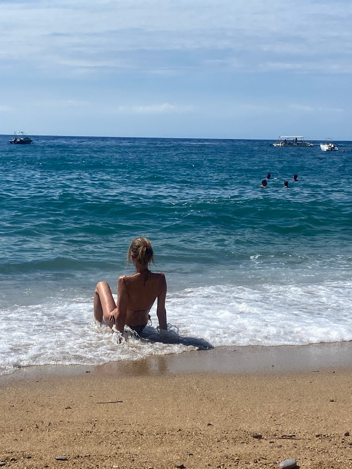 Beach visitors enjoy morning at Sveti Stefan, Montenegro