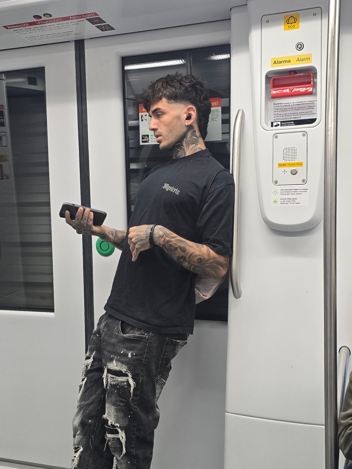 Tattooed commuter spotted on Barcelona Metro during morning rush