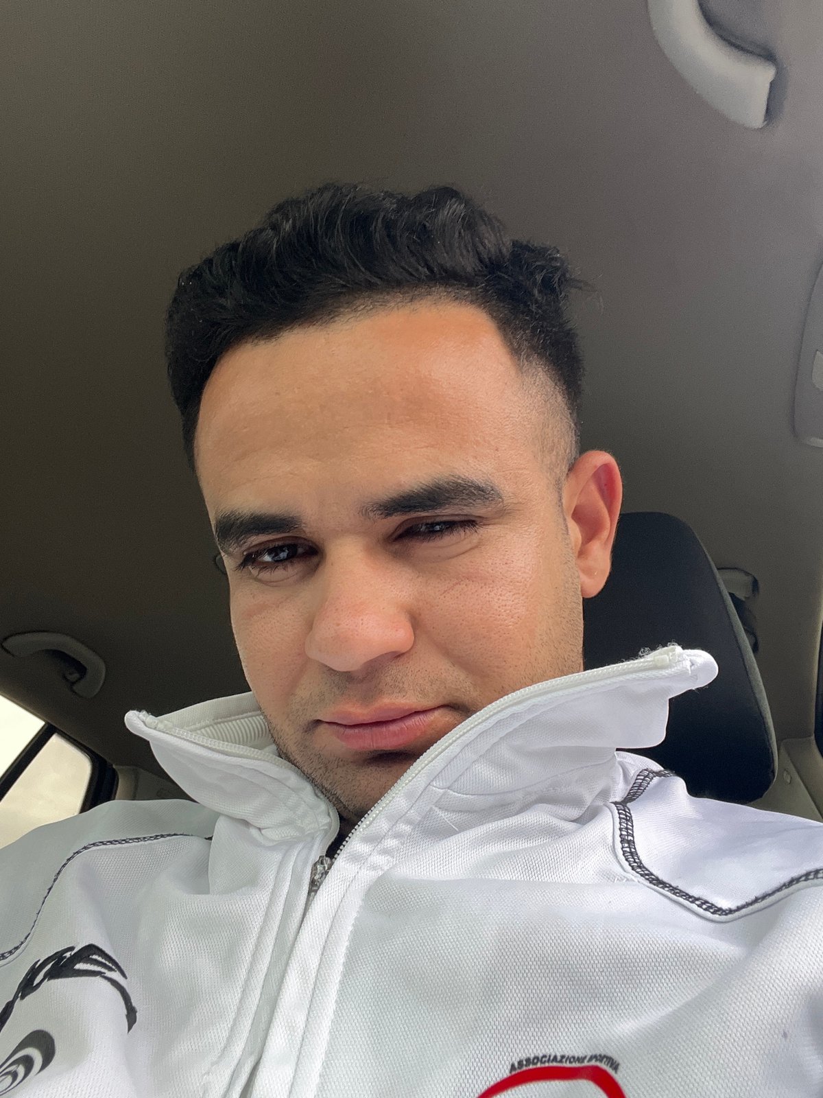 Man takes selfies inside car in Martil, Morocco