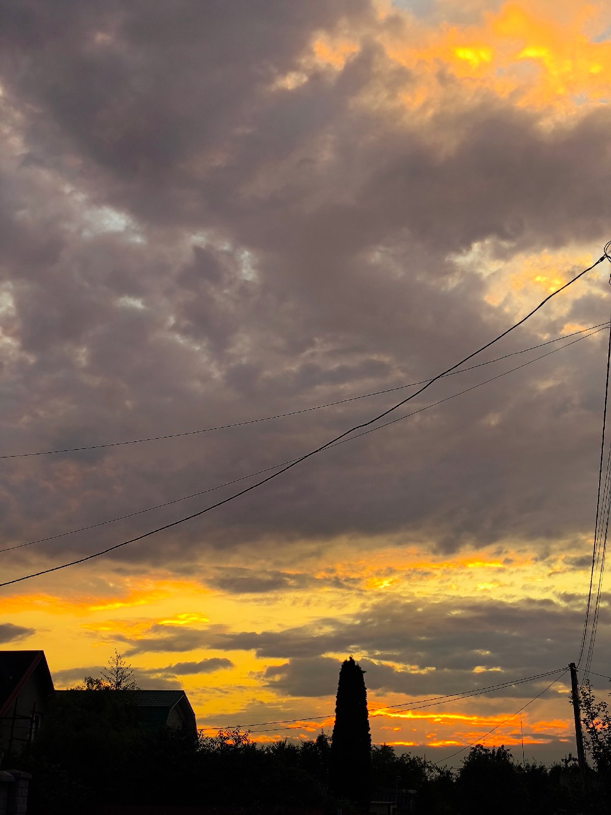 Kaliningrad sunset lights up the sky over rooftops and power lines