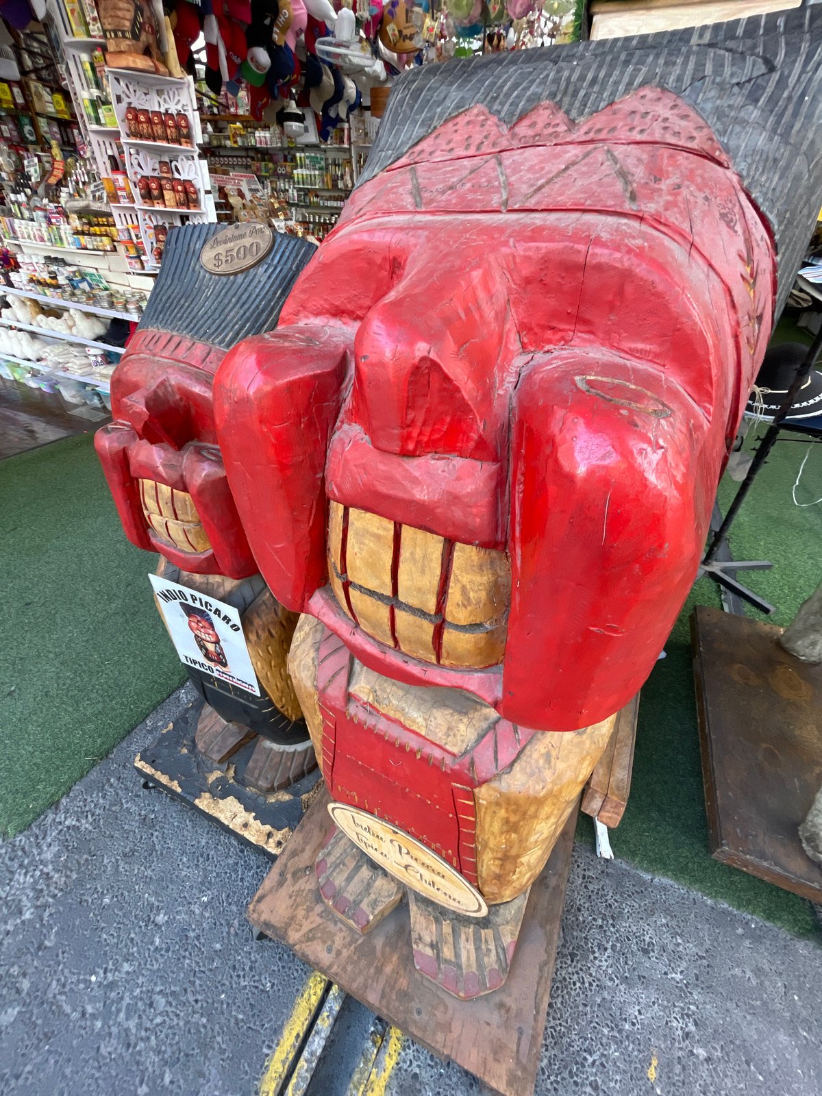Hand-carved wooden sculpture displayed at Iquique market stall