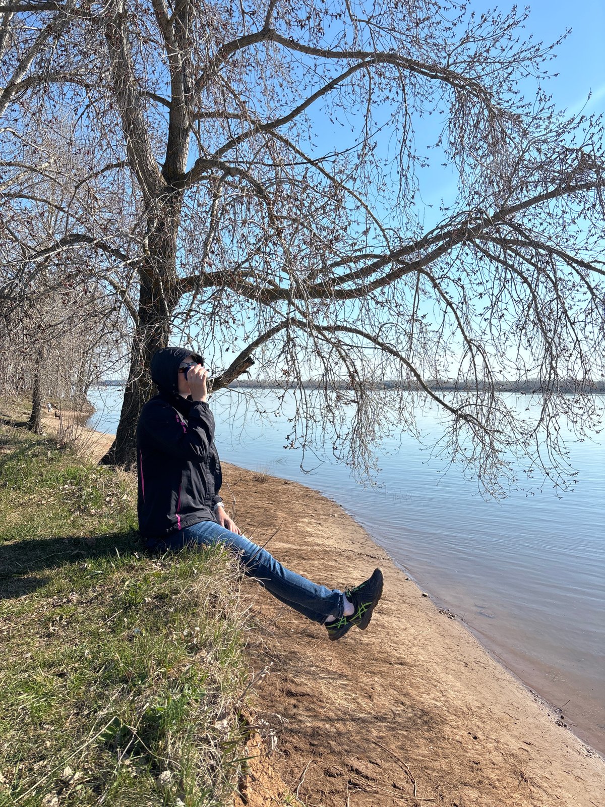 Person rests by water in Chaikovsky, Russia