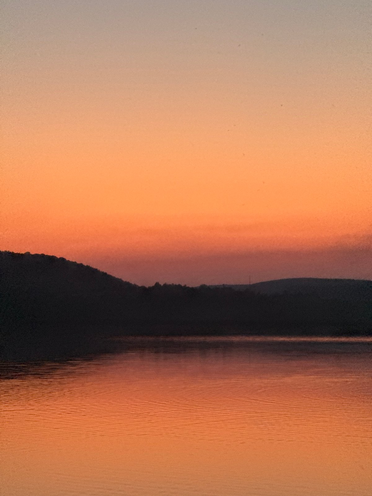 Sunset over a lake in Berezhany, playground on the shore