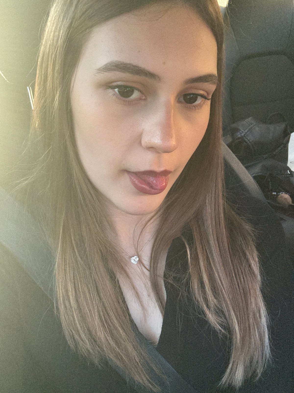 Woman photographed in car wearing silver necklace in Baden-Baden