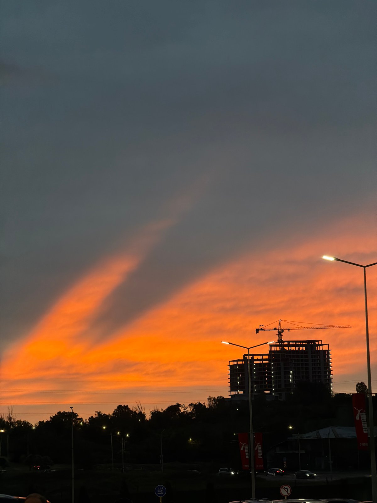 Sunset observed over Yerevan construction site amid cloudy skies