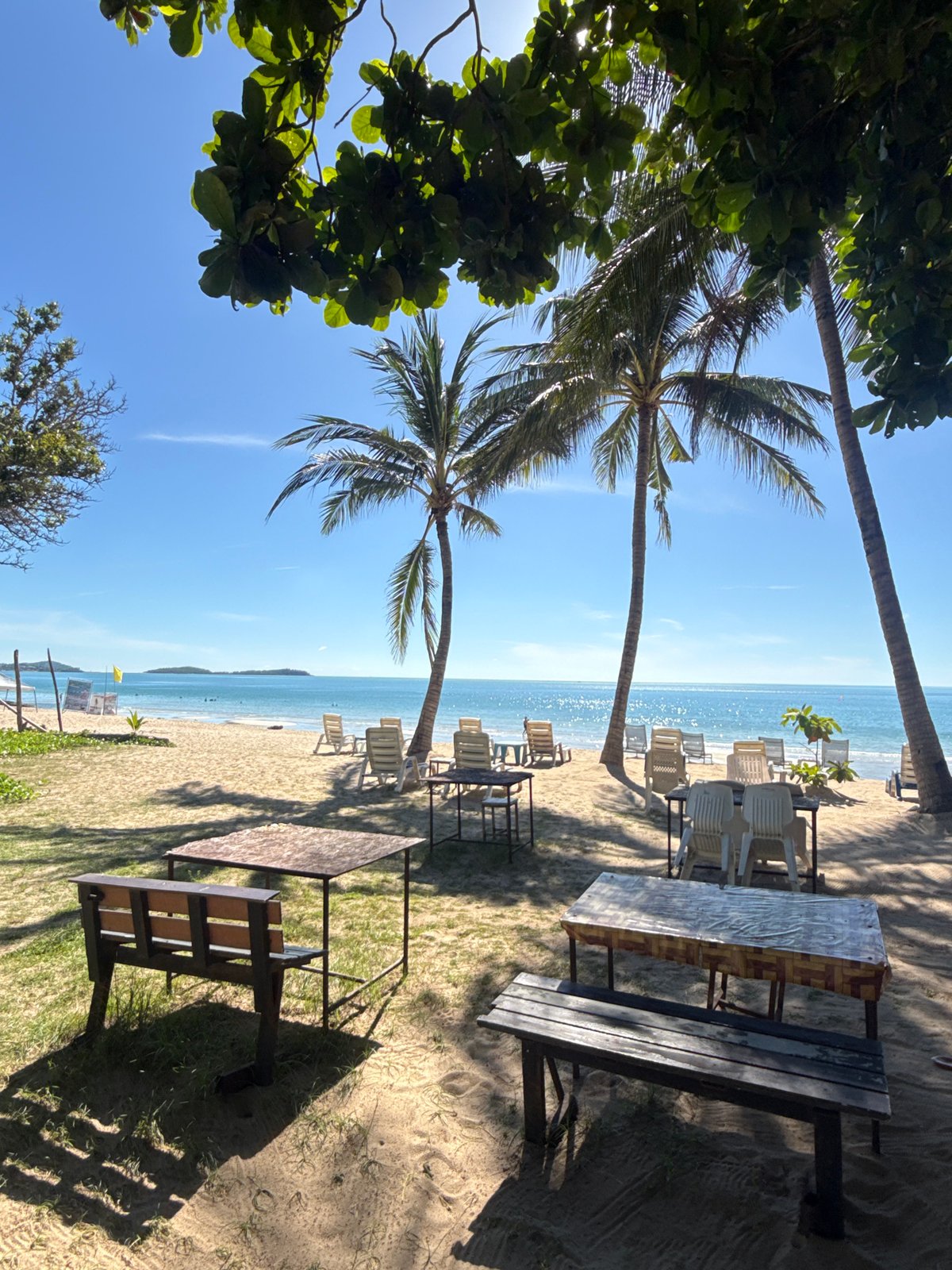 Beach morning in Chaweng Noi: breakfast, shoreline, and a crane crew at work