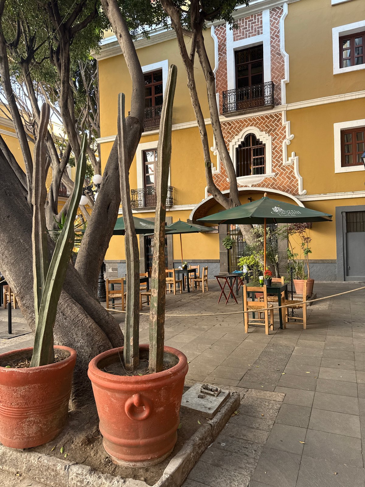 Evening street life documented around historic Puebla church