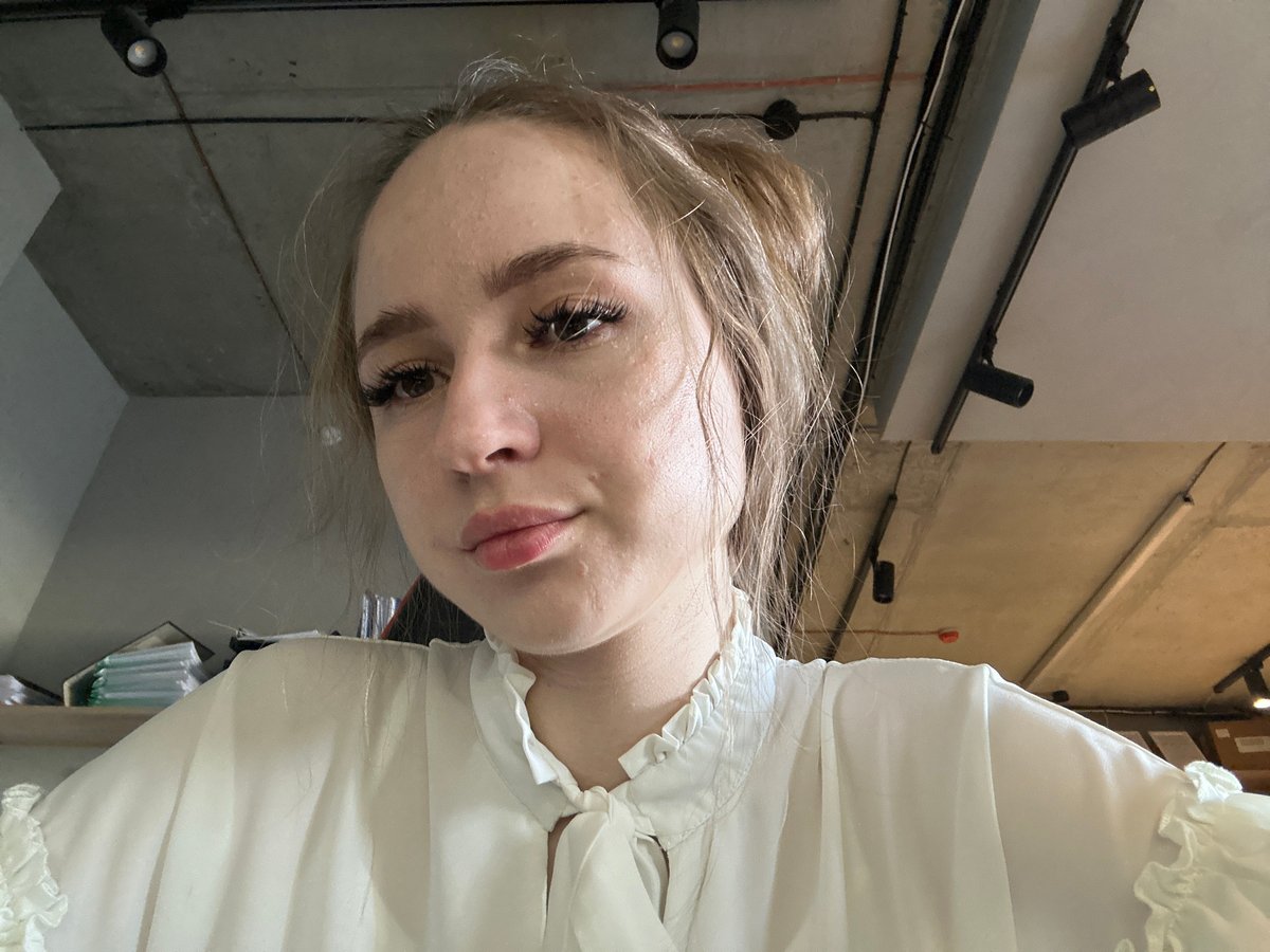 Multiple selfies in an office, white ruffled blouse, gaming chair