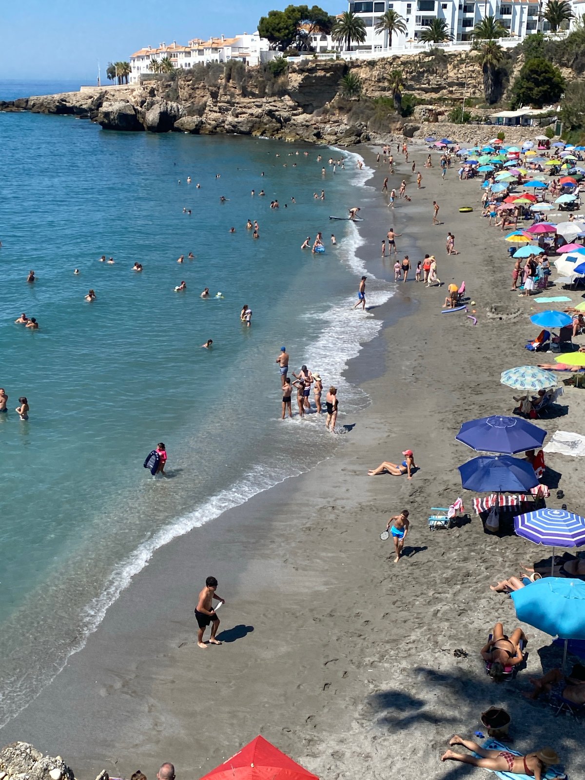 Crowded summer beach day on the Nerja coastline