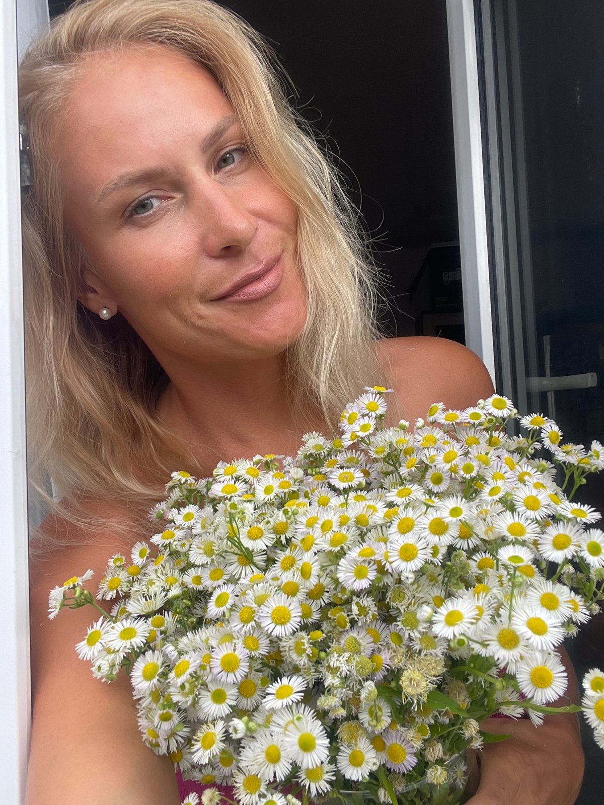 Hamster in the grass, roses, and daisies in Baranovka