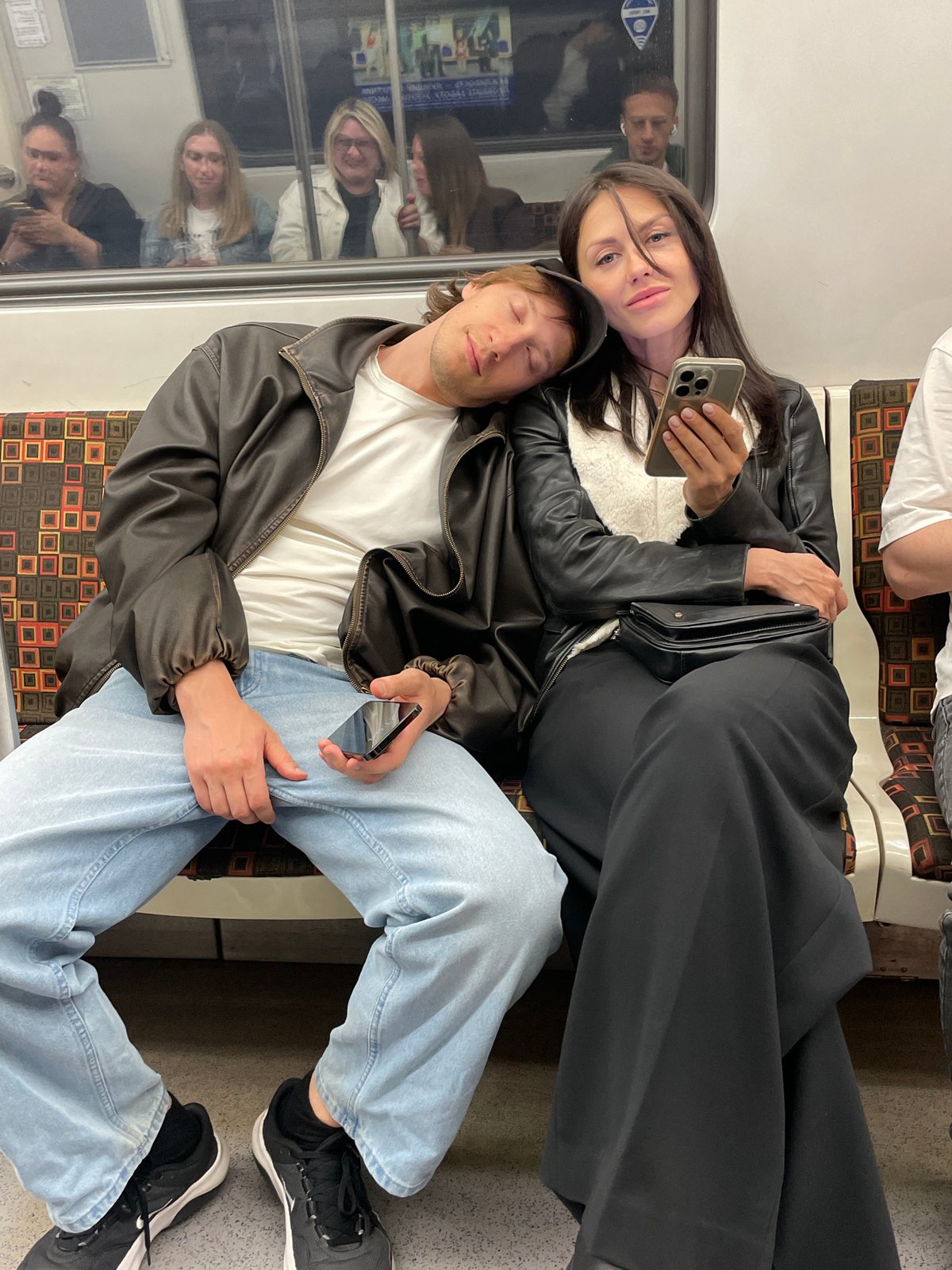 Subway passengers share quiet moments during evening commute