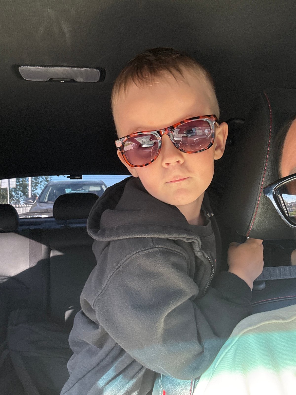 Woman and child spotted in car wearing sunglasses in Chaikovsky
