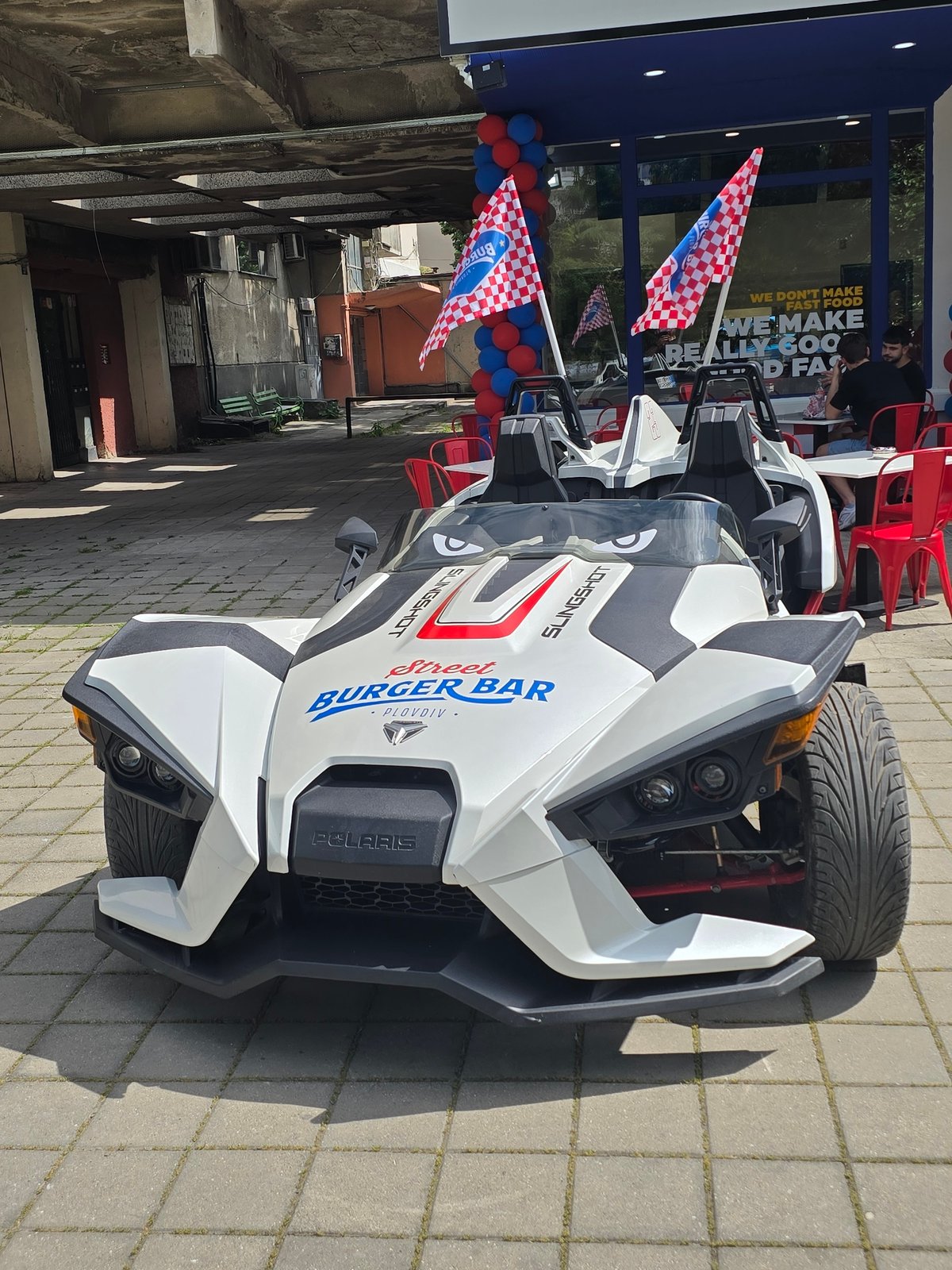 Polaris Slingshot three-wheelers spotted parked in urban commercial area
