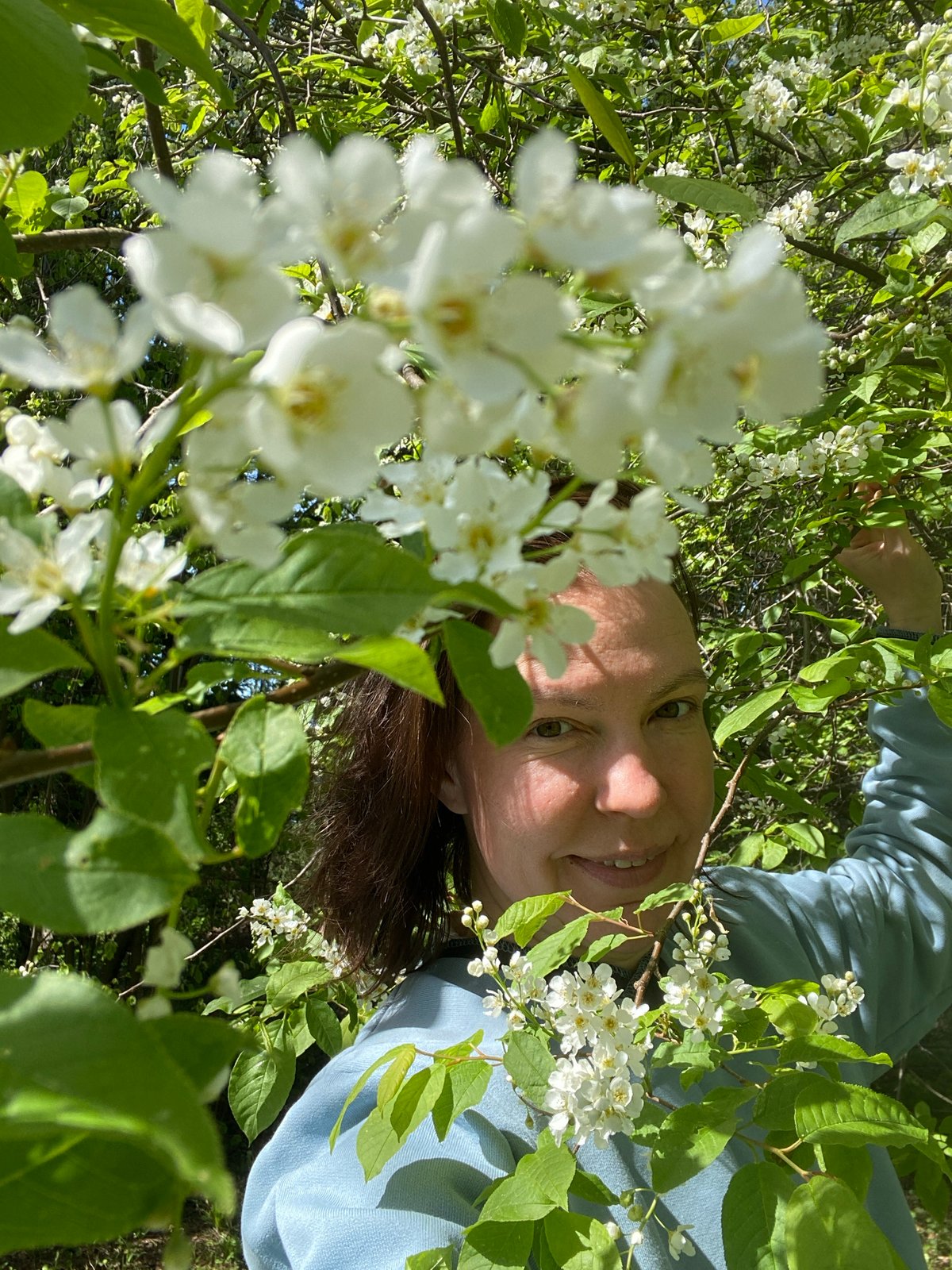 Woman enjoys spring blooms in Russian garden