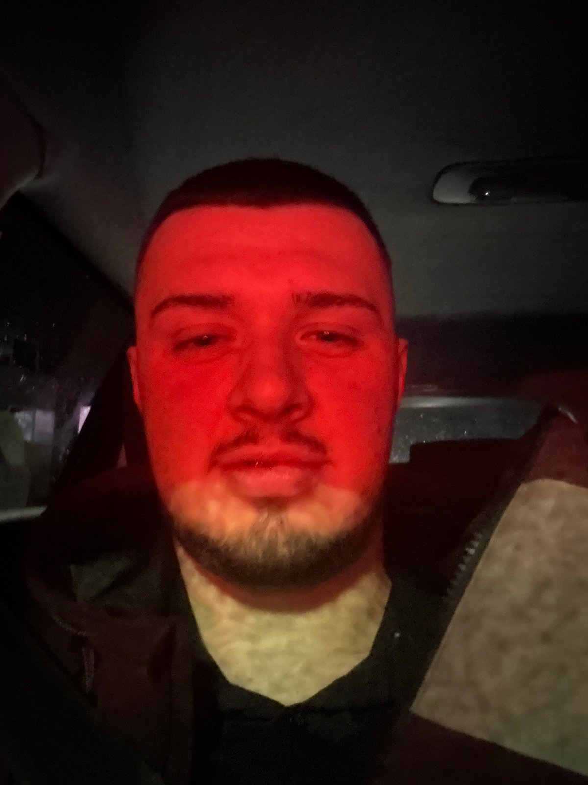 Man photographed under dramatic red lighting in Sofia
