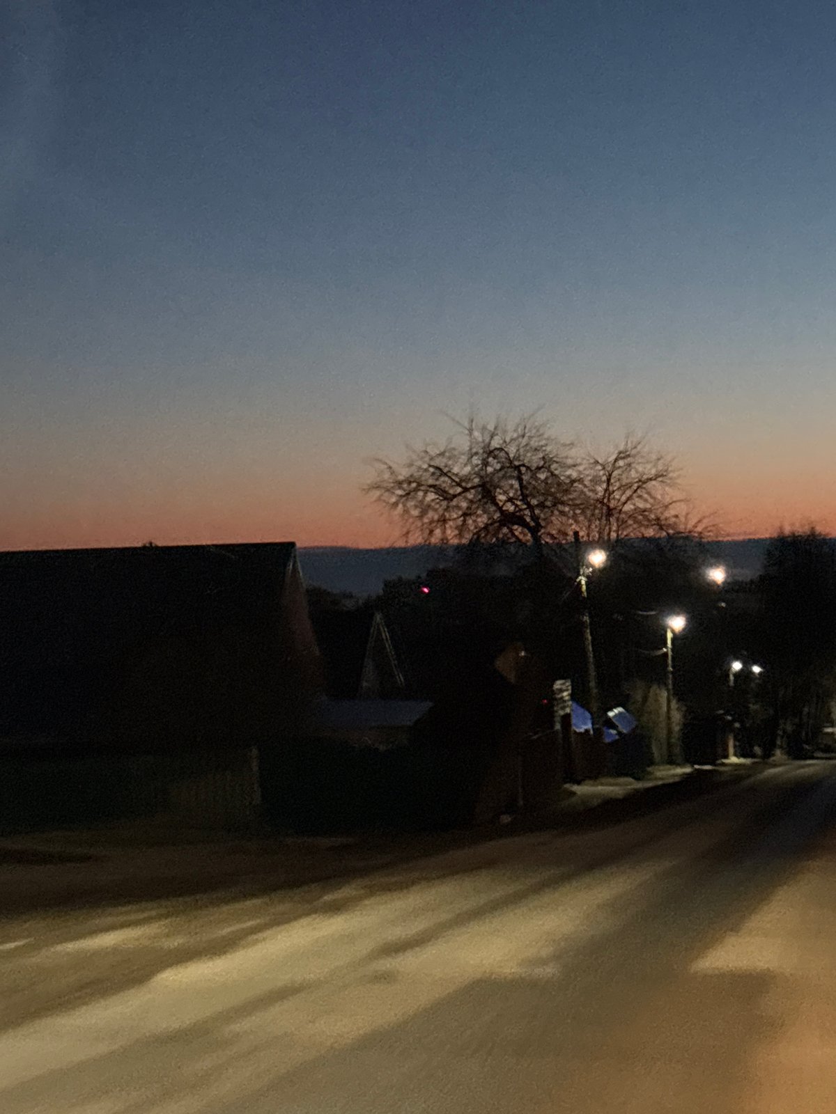 Evening street scene captured at dusk in Chaikovsky, Russia
