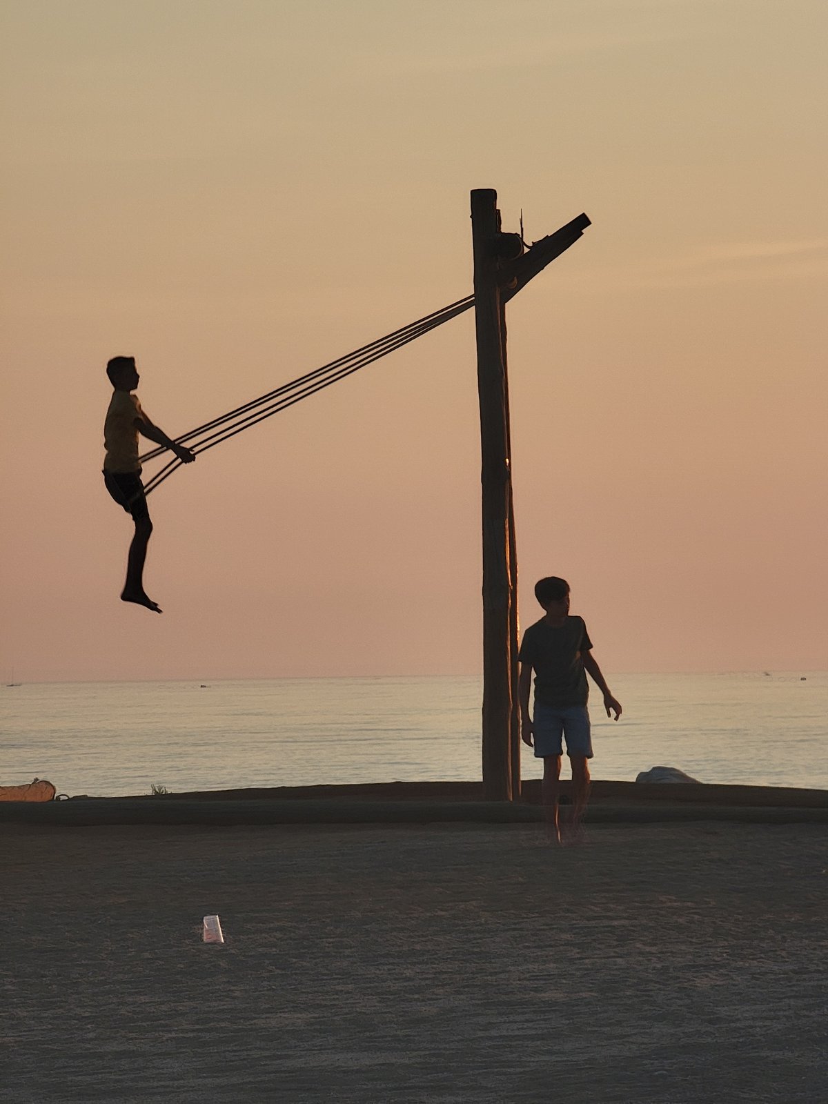 Quarteira beach at golden hour, swimmers and strollers in the mix
