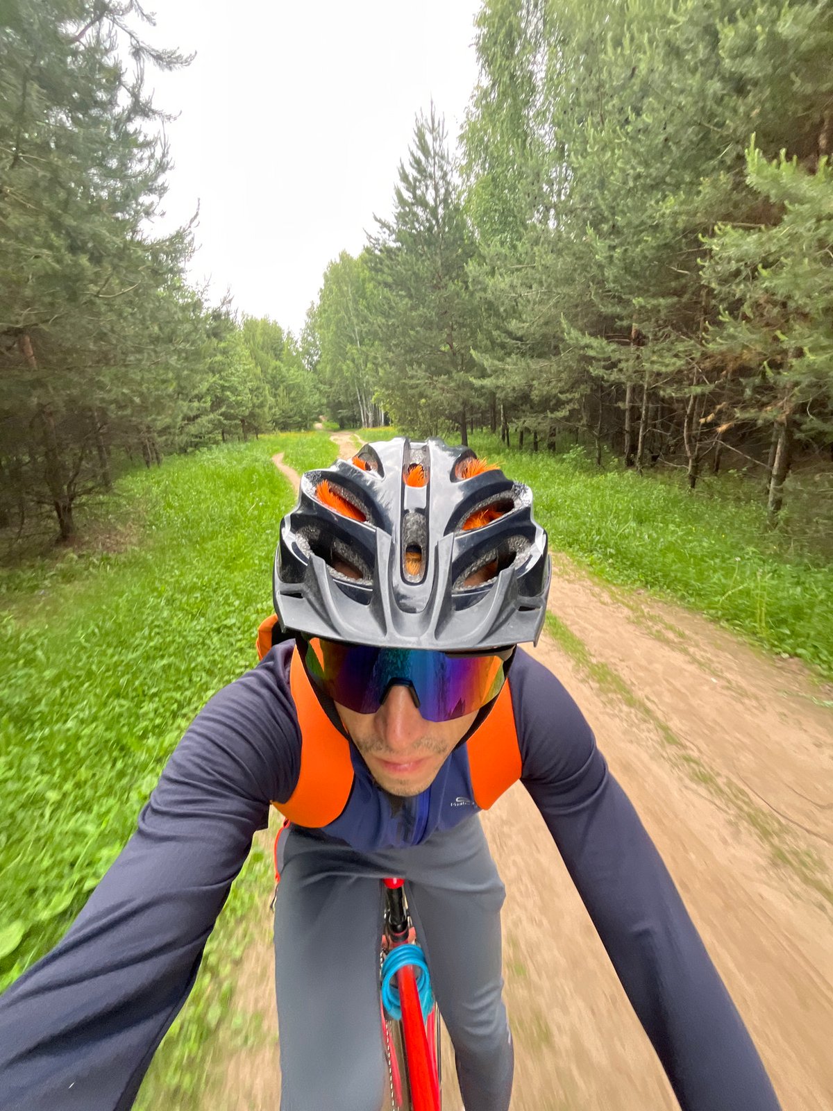 Cyclist rides forest path in Chaikovsky, Russia