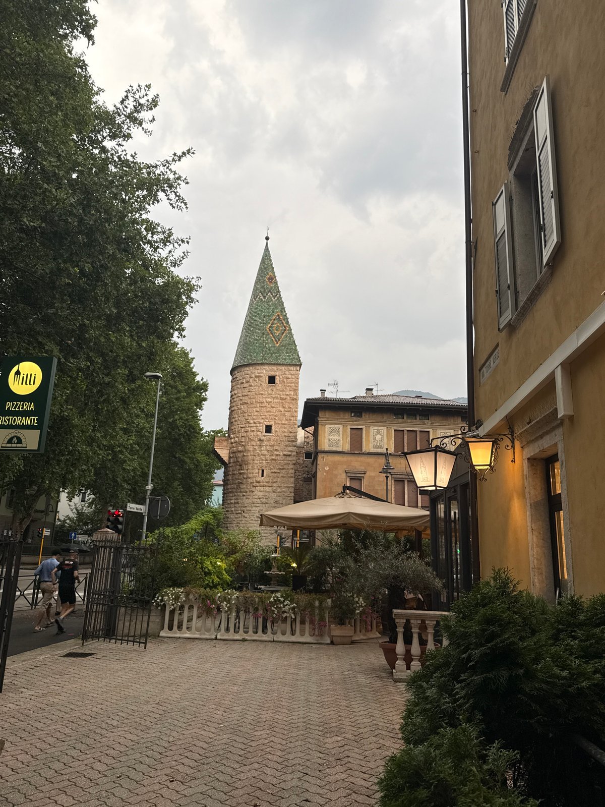 Cycling Trento's wet cobblestone streets past Buonconsiglio Castle